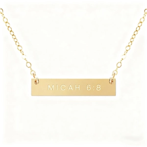 Macro view of gold-plated bar pendant featuring Micah 6:8 scripture engraving