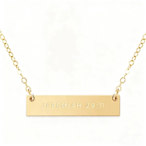 Close-up of gold vertical bar necklace engraved with Jeremiah 29:11 scripture