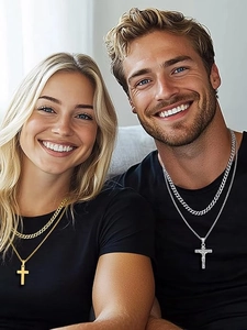 Lifestyle shot of gold and silver layered Cuban necklaces with cross pendants for men and women
