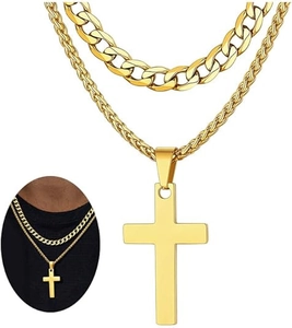 Close-up of golden double-layer necklace set with Cuban link and minimalist cross pendant