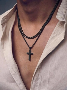 Close-up of matte black stainless steel Cuban link chain and cross pendant necklace