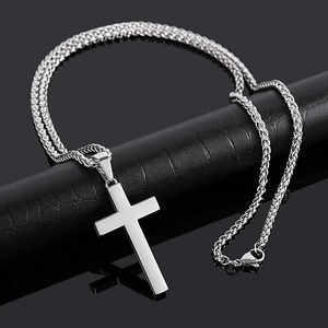 Polished stainless steel cross pendant necklace with wheat chain on black stand