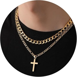 Close-up of double-layered gold Cuban and Figaro chain necklace with a cross pendant