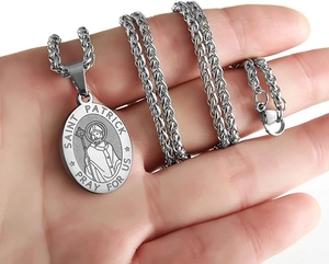 Close-up of Saint Patrick medal pendant with pray for us engraving on braided wheat chain