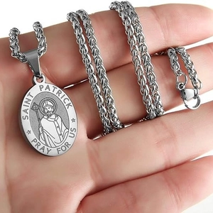 Saint Patrick medal necklace in stainless steel with wheat chain held in hand