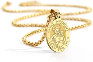 Detailed close-up of golden Saint Anthony oval pendant necklace with engraved prayer