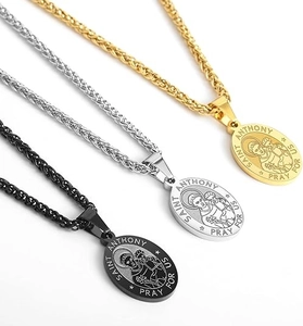 Detailed view of Saint Anthony pendants in gold, silver and black finishes on woven chains
