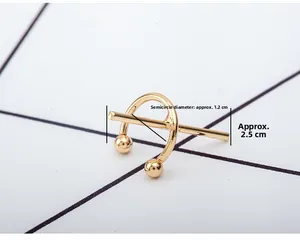 Detail view of gold C-shaped cross ear cuff with 1.2cm diameter and 2.5cm length