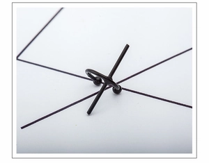 Close-up of black geometric C-shaped cross ear cuff made of matte coated metal