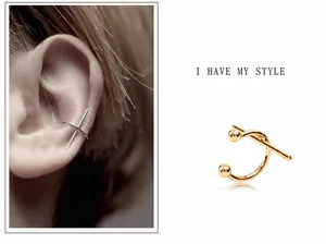 Detailed view of minimalist geometric C-shaped cross ear cuffs in gold and silver plating