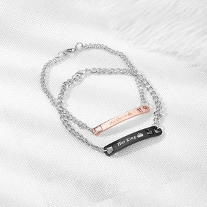 Detail view of His Queen and Her King engraved couple bracelets with small crystals