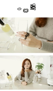 Detail view of matte black minimalist ring set showing three different styles on fingers