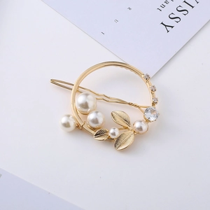 Barrette dorée élégante en forme de feuille avec perles et strass sur fond blanc minimaliste