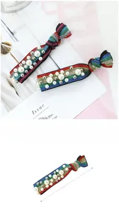 Detailed view of rainbow striped hair ties with white pearls and metal studs, 12.5cm length