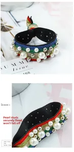 Detail of rainbow stripe scrunchie with pearls and rivets secured by马钉 for durability
