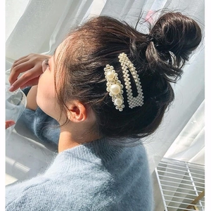Elegant two-piece pearl hair clip set for women styled on a chic bun hairstyle