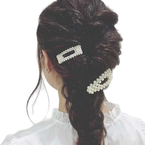 Elegant two-piece pearl hair clip set shown on a model with stylish braided hair