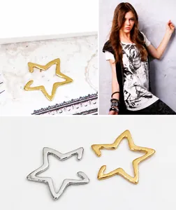 Close-up of minimalist hollow star ear cuffs in polished gold and silver finishes