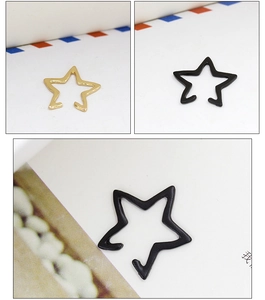 Detail of hollow star-shaped ear clips in gold and black finishes for non-pierced ears