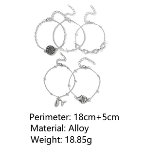 Detail view of 5-piece silver alloy beach bracelet set with shell and cross charms
