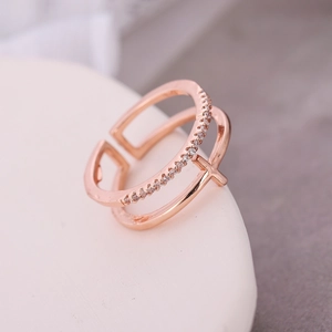 Macro detail of rose gold open ring with double bands and sparkling zircon stones