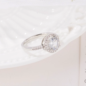 Elegant halo design silver ring with round-cut zircon and pavé setting on white plate