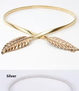 Detail showing elegant feather shaped buckle on metallic elastic spring belt for dresses
