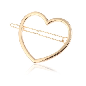 Detailed view of heart-shaped hollow hair clip in polished pale gold finish