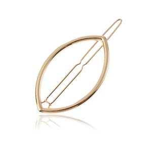 Minimalist gold alloy leaf shaped hair clip with hollow design on white background