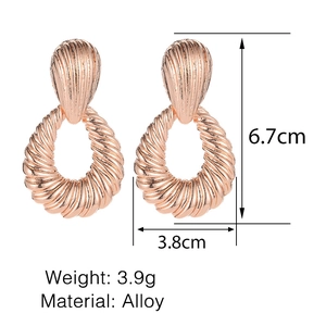 Detailed view of large alloy shell-textured earrings with 6.7cm height measurements