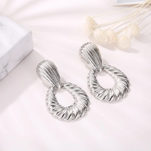 Close-up of silver waterdrop earrings featuring elegant ribbed texture and shell-like ripples