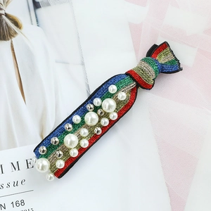 Rainbow glitter fabric hair tie featuring white faux pearls and silver metallic beads