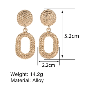 Detailed size measurement of vintage gold alloy earrings with textured oval design