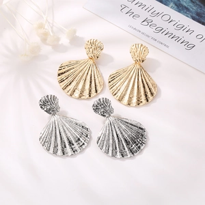 Detailed view of alloy shell drop earrings featuring golden and silver ribbed texture