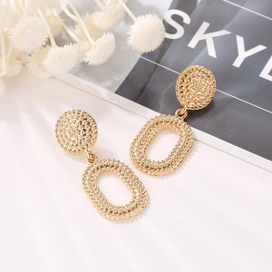 Vintage golden hollow oval drop earrings with detailed granular texture and retro style