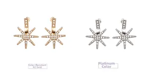 Detail of star-shaped stud earrings in KC gold and white gold with pave set crystals