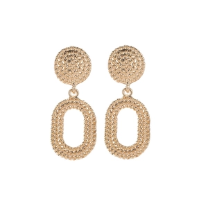 Detail of vintage oval gold earrings with a granulated metal texture on white background