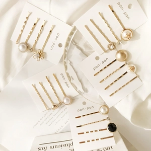 Elegant 4-piece set of gold hair clips with faux pearls, bee motif, and black gemstone