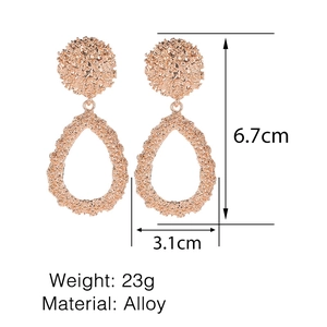 Detailed view of rose gold water drop earrings with lava texture showing 6.7cm by 3.1cm size