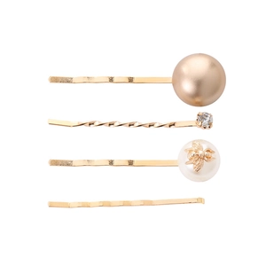 Detail of four-piece gold hair clip set with pearls, rhinestones and bee motif