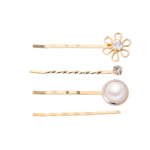Detail of four-piece gold hair clip set with pearls, rhinestones, and floral designs