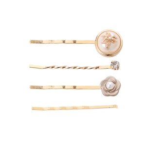 Detailed set of four golden hair clips featuring a pearl bee, camellia, and crystal accents