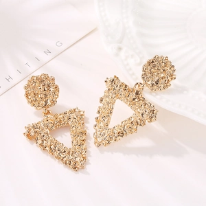 Textured gold triangle drop earrings with irregular embossed finish and geometric design