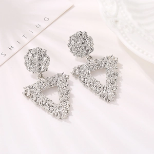 Silver geometric earrings with hammered metal texture in circular and triangle shapes