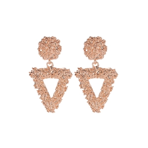 Detail of rose gold geometric triangle earrings featuring a unique hammered metal texture