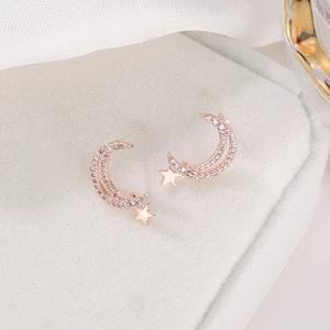 Star and moon stud earrings in rose gold with zircon stones on velvet display