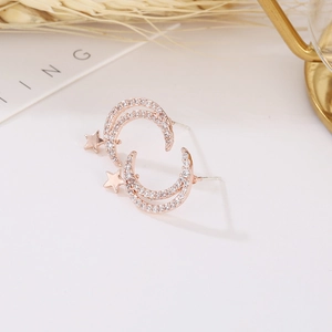Close-up of rose gold star and moon stud earrings with micro-set sparkling cubic zirconia