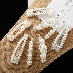 Elegant artificial pearl hair clip set with multiple designs on a woven display board