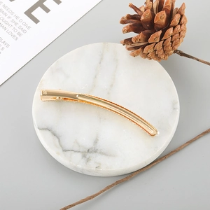 Detail of elegant gold-plated duckbill hair clip with sparkling rhinestones decoration