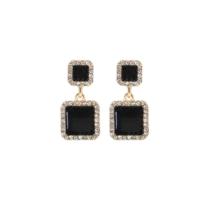 Detailed view of square black enamel earrings with gold plating and cubic zirconia halo